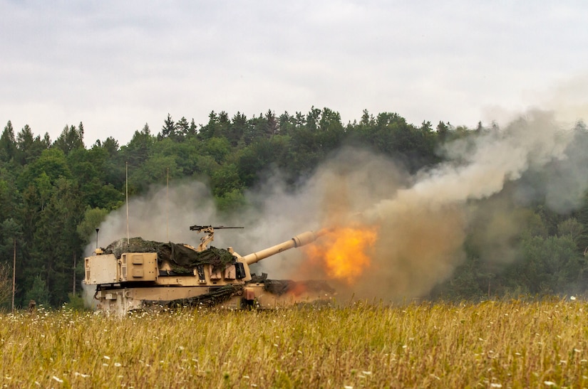 A self-propelled howitzer fires.