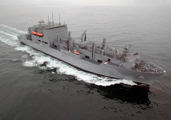 Dry Cargo/Ammunition Ship. Deliver supplies to customer ships at sea — ammunition, food, repair parts, stores and small quantities of fuel. Replace T-AE, T-AFS and T-AOE when operating with T-AO. Two dedicated ships provide ammunition, food, repair parts, stores and small quantities of fuel for the U.S. Marine Corps. Length: 689 ft, Beam: 106 ft, Displacement: 41,000 tons, Speed: 20 knots, Civilian: 129. Government-owned
