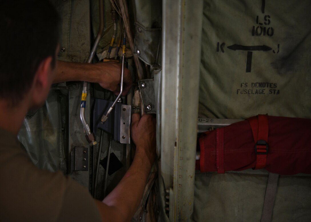 Tech. Sgt. Ryan McBride, 19th Maintenance Squadron NCO in charge of metals technology, mounts a new 3D printed hydraulic pump bracket at Little Rock Air Force Base, Arkansas, June 4, 2020. McBride pursued his idea of 3D printing the bracket by collaborating with Airmen from the Air Force Life Cycle Management Center. (U.S. Air Force photo by Airman 1st Class Jayden Ford)
