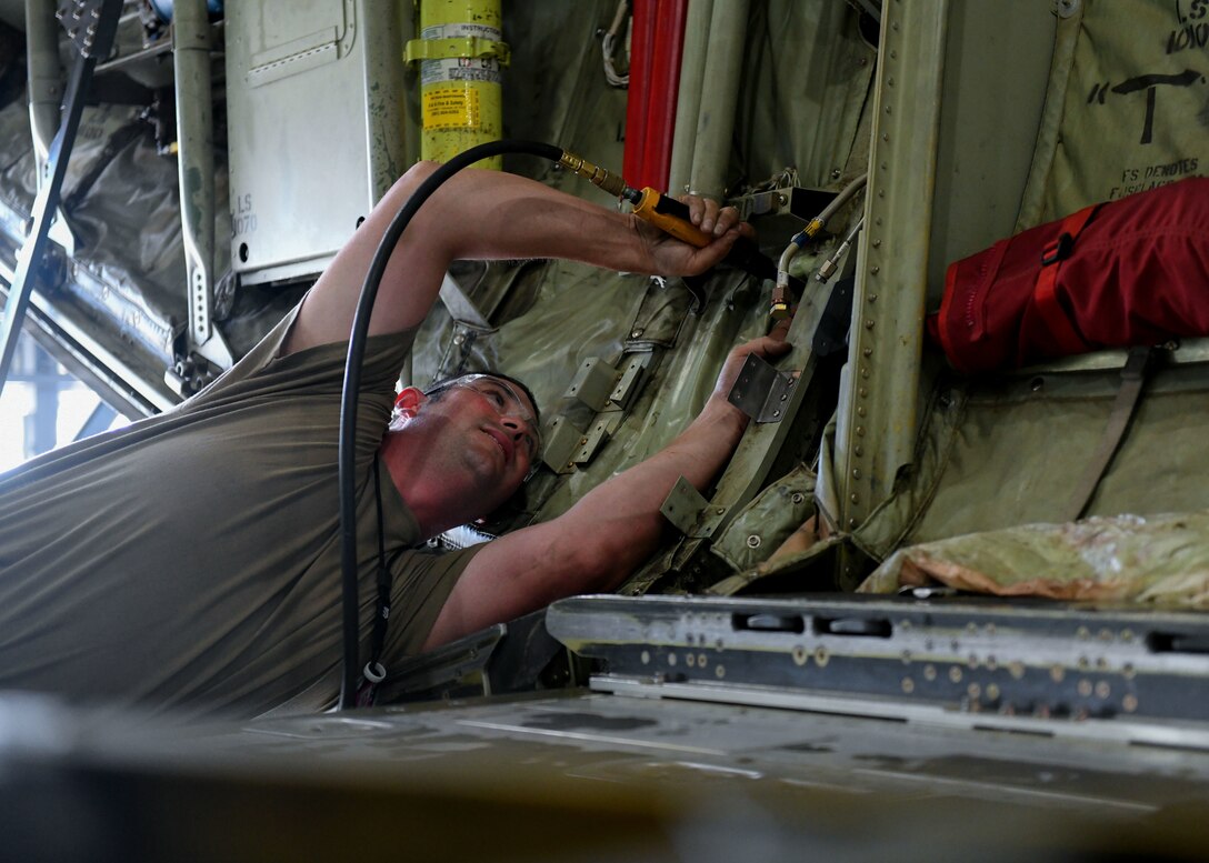 Tech. Sgt. Jason Felts, 19th Maintenance Squadron sheet metal production lead, drills a hole in a new 3D printed hydraulic pump bracket at Little Rock Air Force Base, Arkansas, June 4, 2020. The re-creation of the part acted as an opportunity to completely revamp the structure and strength of the part to decrease the amount of repairs that are needed over time. (U.S. Air Force photo by Airman 1st Class Jayden Ford)