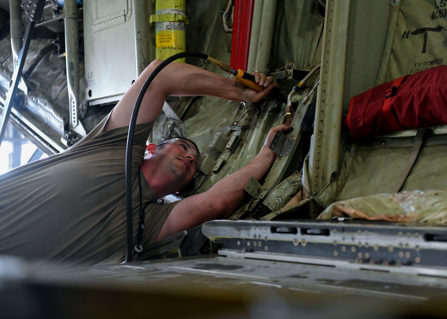 Tech. Sgt. Jason Felts, 19th Maintenance Squadron sheet metal production lead, drills a hole in a new 3D printed hydraulic pump bracket at Little Rock Air Force Base, Arkansas, June 4, 2020. The re-creation of the part acted as an opportunity to completely revamp the structure and strength of the part to decrease the amount of repairs that are needed over time. (U.S. Air Force photo by Airman 1st Class Jayden Ford)