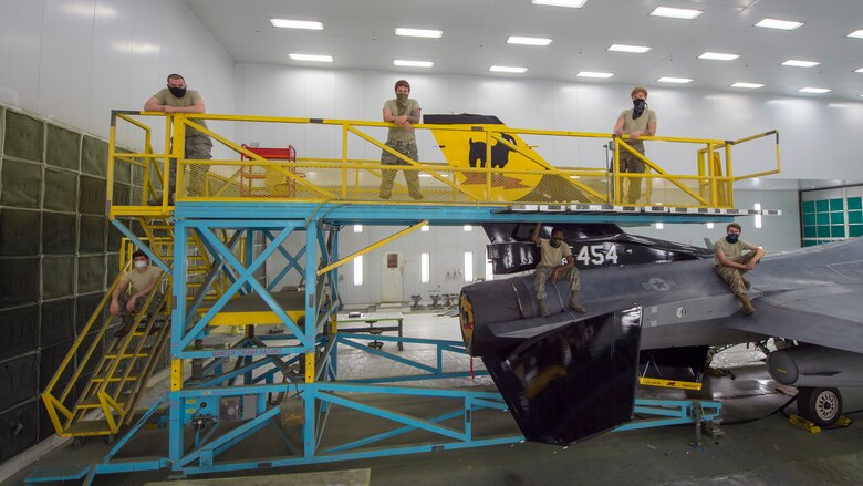 Airmen from the 8th Aircraft Maintenance Unit pose for a photo, June 4, 2020, on Holloman Air Force Base, N.M. The team of Airmen were described by the 49th Equipment Maintenance Squadron wing corrosion manager, Tech. Sgt. William Garcia, as hardworking, dedicated and self-motivated in regards to their workmanship during the 5 to 11 day process of painting. (U.S. Air Force photo by Senior Airman Collette Brooks)