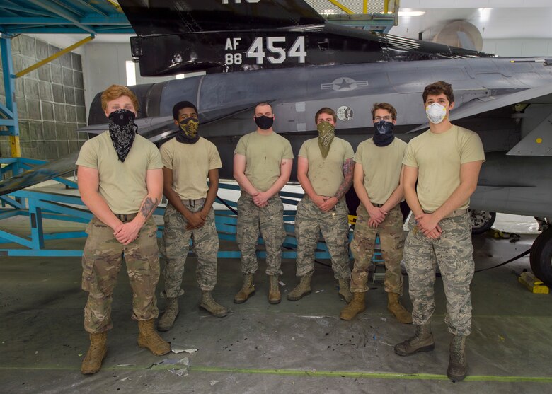Airmen from the 8th Aircraft Maintenance Unit, pose for a photo, June 4, 2020, on Holloman Air Force Base, N.M. The team of Airmen were described by the 49th Equipment Maintenance Squadron wing corrosion manager, Tech. Sgt. William Garcia, as hardworking, dedicated and self-motivated in regards to their workmanship during the 5 to 11 day process of painting. (U.S. Air Force photo by Senior Airman Collette Brooks)