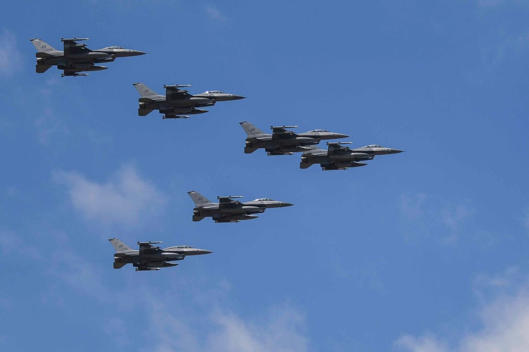 Six Air Force aircraft fly in formation.