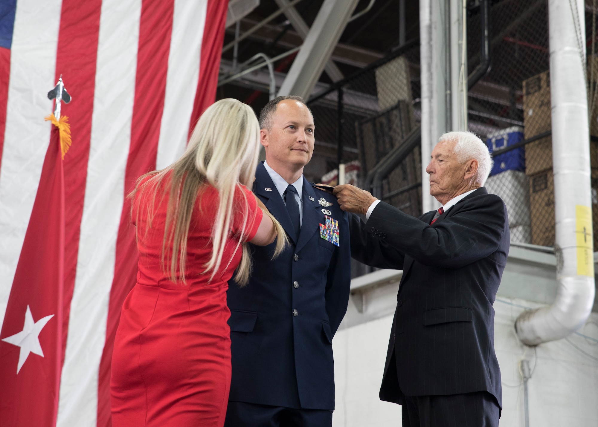 Col. Daniel Boyack, commander Utah Air National Guard, is pinned on by his wife, Michelle and father, Lt. Col (ret) Paul Boyack, as he promotes to the rank of Brigadier General