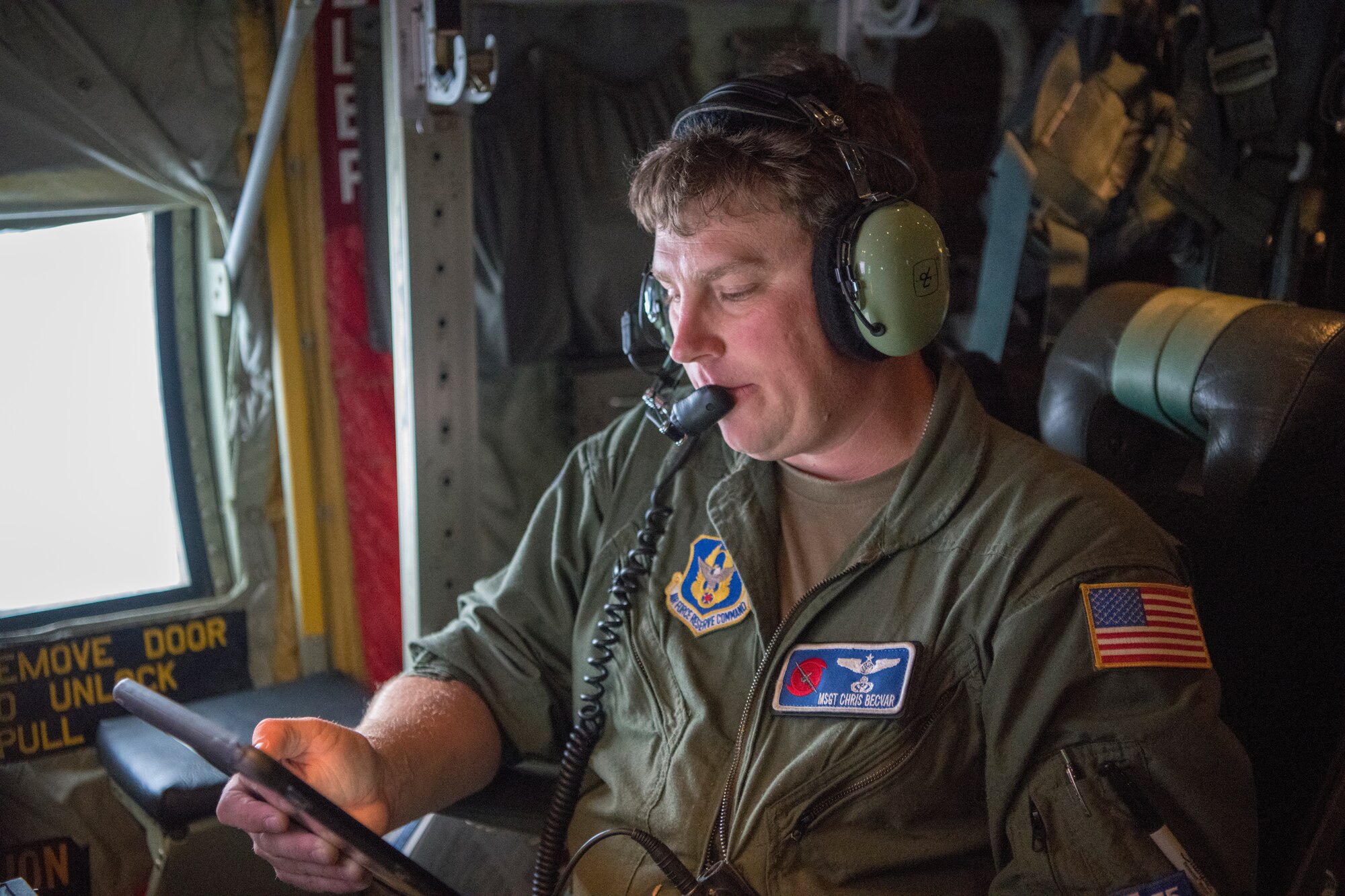 Master Sgt. Chris Becvar, 53rd Weather Reconnaissance Squadron loadmaster, reviews the flight data on his tablet June 5, 2020 over the Gulf of Mexico. The Hurricane Hunters were tasked to fly a fixed mission to locate the center of Tropical Storm Cristobal and the data gathered was sent to the National Hurricane Center for their weather model forecasts. (U.S. Air Force Photo by Tech. Sgt. Christopher Carranza)