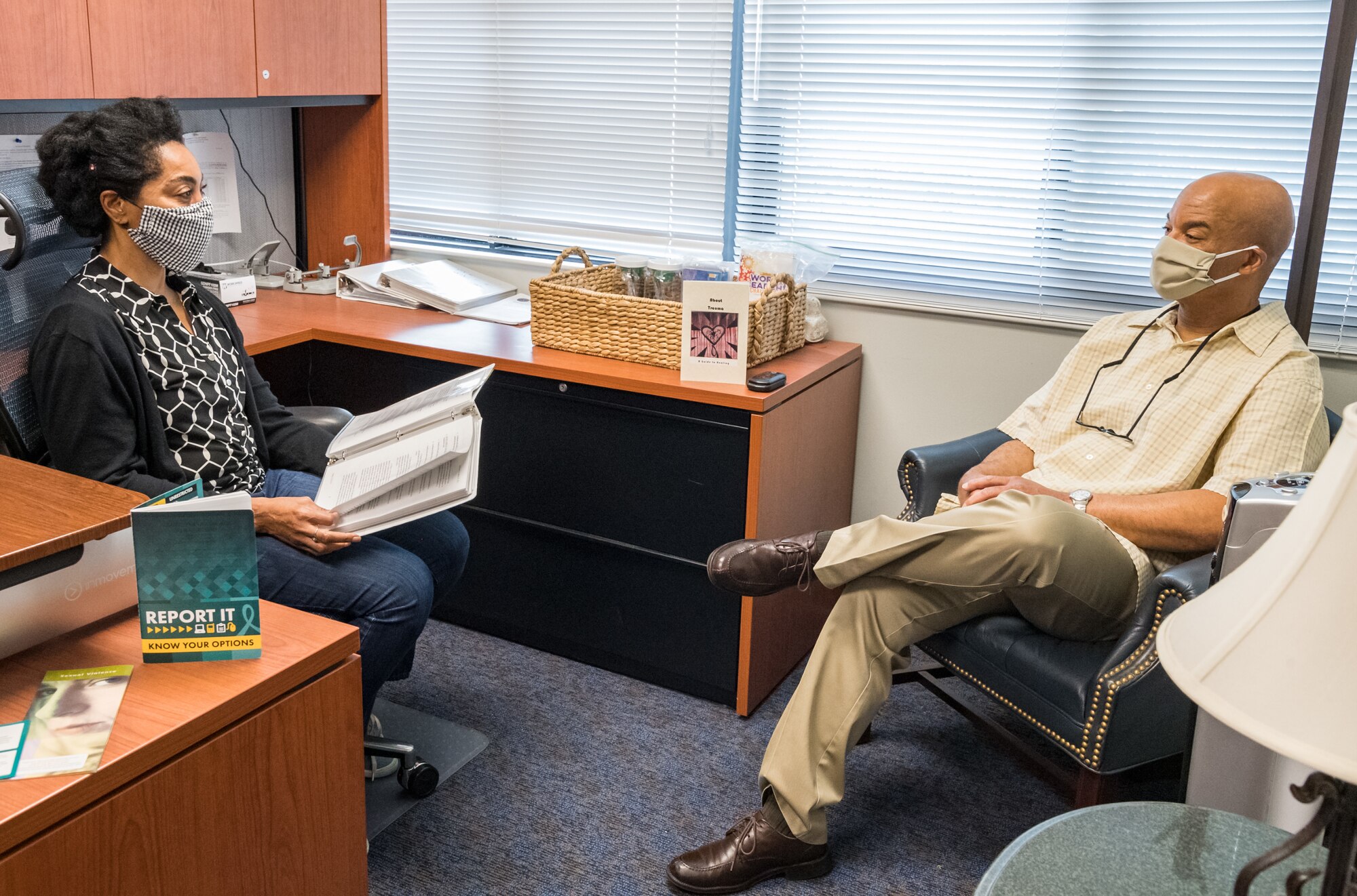 Gail Reed-Attoh, 436th Airlift Wing Sexual Assault Response Coordinator, and Wilbert Roberson, 436th AW Sexual Assault Prevention and Response victim advocate, review program reporting procedures May 29, 2020, at Dover Air Force Base, Delaware. The SAPR program provided support for sexual assault victims during significantly reduced manning and continues to offer services throughout the COVID-19 pandemic. (U.S. Air Force photo by Roland Balik)