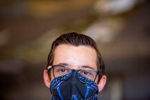Airman 1st Class Gabriel Leal, 311th Aircraft Maintenance Unit avionics journeyman, smiles for the camera, June 4, 2020, on Holloman Air Force Base, N.M. Three Airmen from the 311th AMU are replacing 11 wire harnesses throughout the plane that range up to 90 feet of wiring, which can take up to three months to repair. (U.S. Air Force photo by Staff Sgt. Christine Groening)
