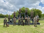 Military working dog handler training students from the Army, Air Force, Marine Corps and Navy pose for a photo following a K-9 demonstration for the Fair Oaks, Texas, Rotary Club June 3, 2020, at Joint Base San Antonio-Lackland.