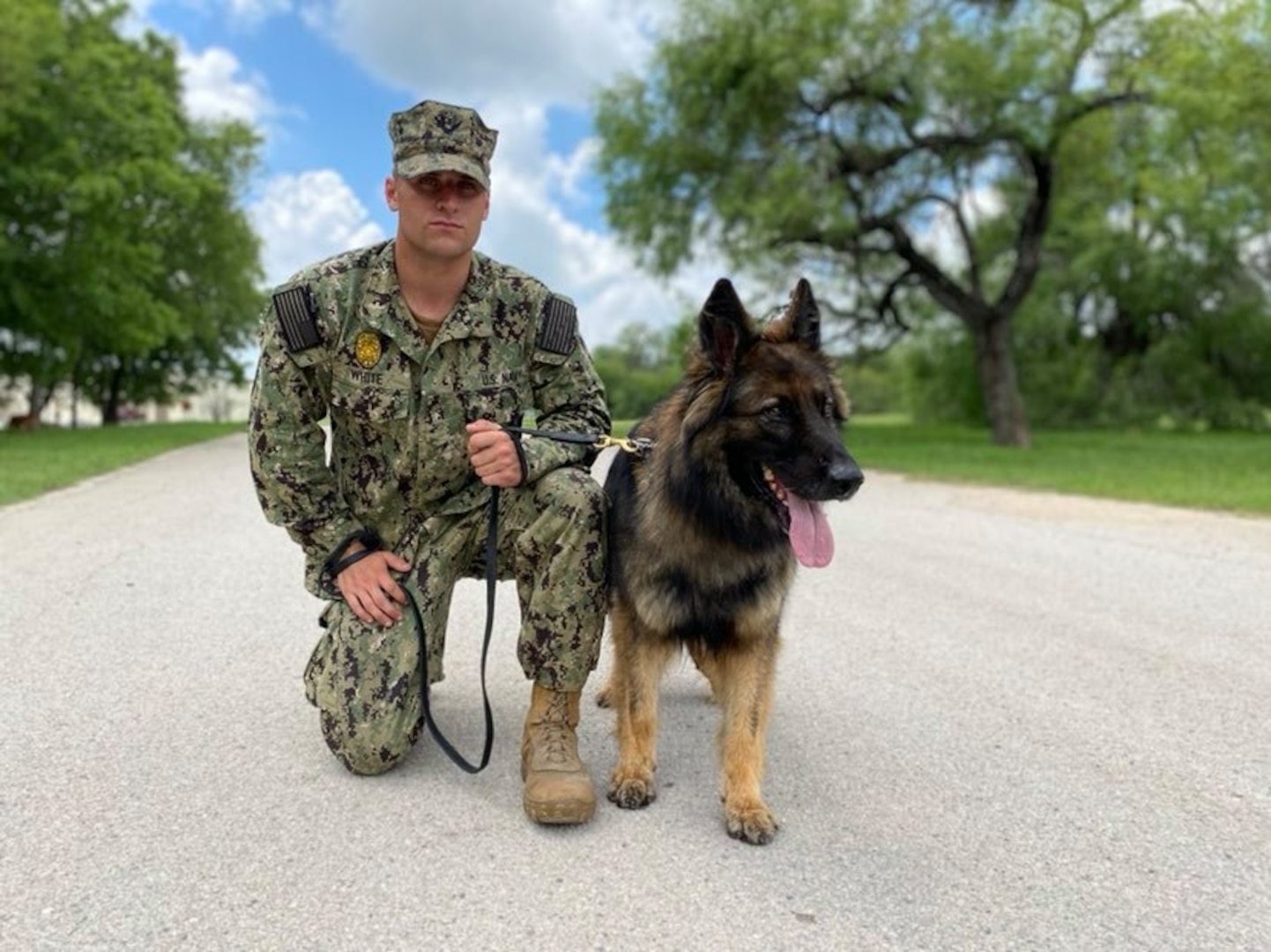 A Military Working Dog handler who trains students from the Navy poses for a photo following participation in a K-9 demonstration for the Fair Oaks, Texas, Rotary Club June 3, 2020, at Joint Base San Antonio-Lackland.