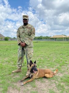 A military working dog handler who trains students from the Air Force poses for a photo following participation in a K-9 demonstration for the Fair Oaks, Texas, Rotary Club June 3, 2020, at Joint Base San Antonio-Lackland.