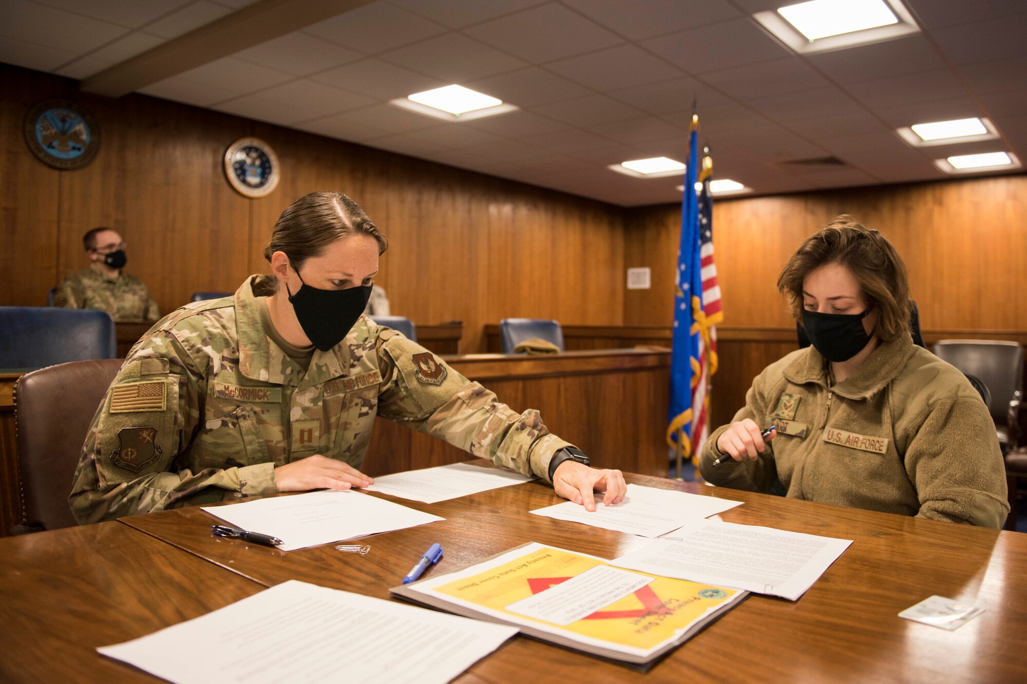 U.S. Air Force Capt. Lauren McCormick, 501st CSW Judge Advocate Office chief of operations and civil law, assists Senior Airman Ashley Kot, 423rd Security Forces Squadron operations support, with her will June 2, 2020, at RAF Alconbury, England. The 501st Combat Support Wing legal office hosted a deployment brief and will execution ceremony for all Security Forces deploying in the next 60 days. (U.S. Air Force photo by Airman 1st Class Jennifer Zima)