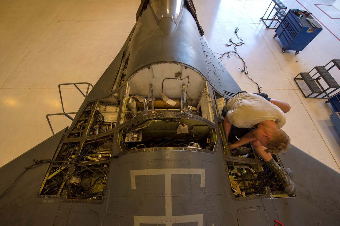 Senior Airman Brian Raatz, 311th Aircraft Maintenance Unit F-16 crew chief performs maintenance on a F-16, June 4, 2020, on Holloman Air Force Base, N.M. Airmen from the 311th AMU are replacing 11 wire harnesses in the 31-year-old aircraft that caught fire last year. (U.S. Air Force photo by Staff Sgt. Christine Groening)