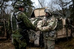 Sgt Azeez Bilaali (right), a psychological operations specialist assigned to 351st Tactical Psychological Operations Company in Fort Totten, N.Y., shakes hands with Sgt. Rimas Rimkus, a soldier in the Lithuanian armed forces, after a mission brief during the Allied Spirit VII training evercise in Grafenwoehr, Germany on Nov. 17, 2017. The U.S. Army, along with its allies and partners, continues to forge a dynamic presence with a powerful land network that simultaneously deters aggression and assures the security of the region. Approximately 3,700 service members from 13 nations gathered in 7th Army Training Command’s Hohenfels Training Area in southeastern Germany to participate in the seventh iteration of Allied Spirit, which is scheduled from Oct. 30 - Nov. 22, 2017. (U.S. Army photo by Spc. Dustin D. Biven / 22nd Mobile Public Affairs Detachment)