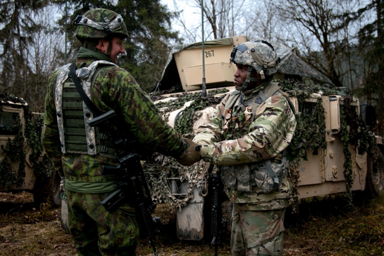 Sgt Azeez Bilaali (right), a psychological operations specialist assigned to 351st Tactical Psychological Operations Company in Fort Totten, N.Y., shakes hands with Sgt. Rimas Rimkus, a soldier in the Lithuanian armed forces, after a mission brief during the Allied Spirit VII training evercise in Grafenwoehr, Germany on Nov. 17, 2017. The U.S. Army, along with its allies and partners, continues to forge a dynamic presence with a powerful land network that simultaneously deters aggression and assures the security of the region. Approximately 3,700 service members from 13 nations gathered in 7th Army Training Command’s Hohenfels Training Area in southeastern Germany to participate in the seventh iteration of Allied Spirit, which is scheduled from Oct. 30 - Nov. 22, 2017. (U.S. Army photo by Spc. Dustin D. Biven / 22nd Mobile Public Affairs Detachment)