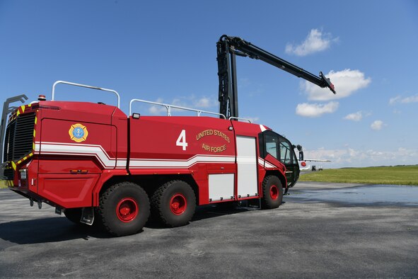 Photo shows Fire Truck with elevated boom extended above it.