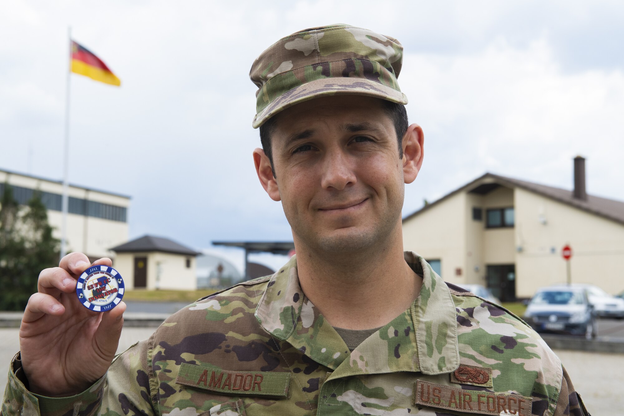 U.S. Air Force Senior Airman Ryan Amador, 52nd Maintenance Squadron Air Force repair enhancement technician, holds the 52nd Fighter Wing commander's Top Innovator coin at Spangdahlem Air Base, Germany, June 8, 2020. Amador was awarded the coin and recognized for his efforts and contribution to the 52nd FW. (U.S. Air Force photo by Airman 1st Class Alison Stewart)