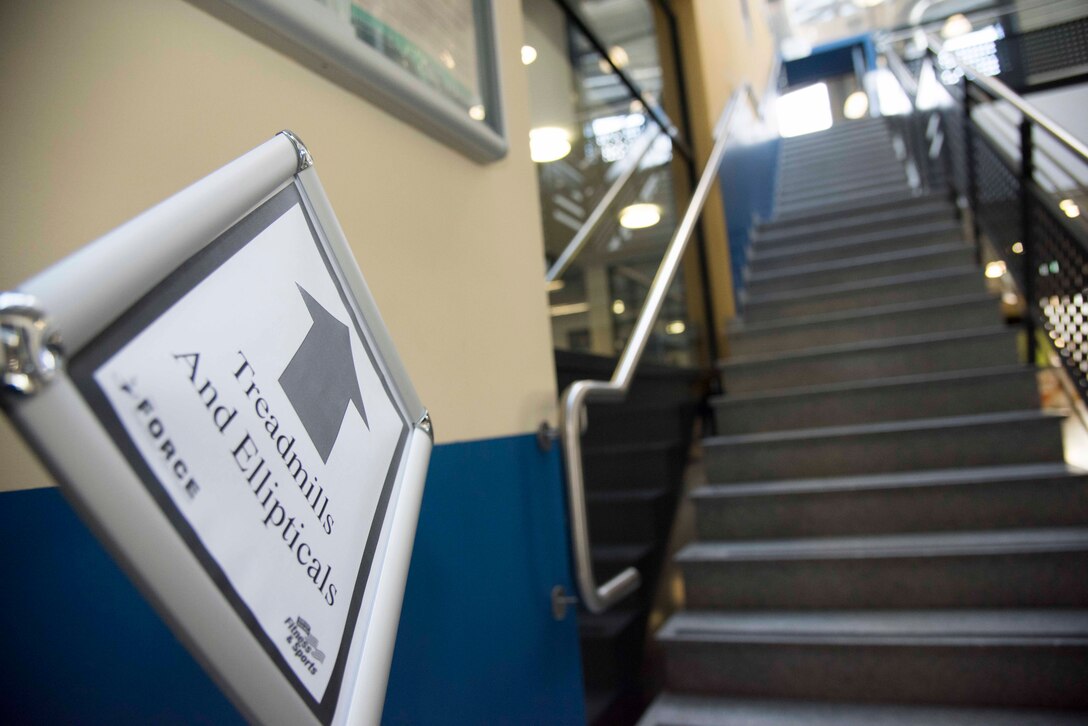 A sign directs customers to the treadmills and elliptical machines in the 786th Force Support Squadron Southside Fitness Center at Ramstein Air Base, Germany, June 8, 2020.