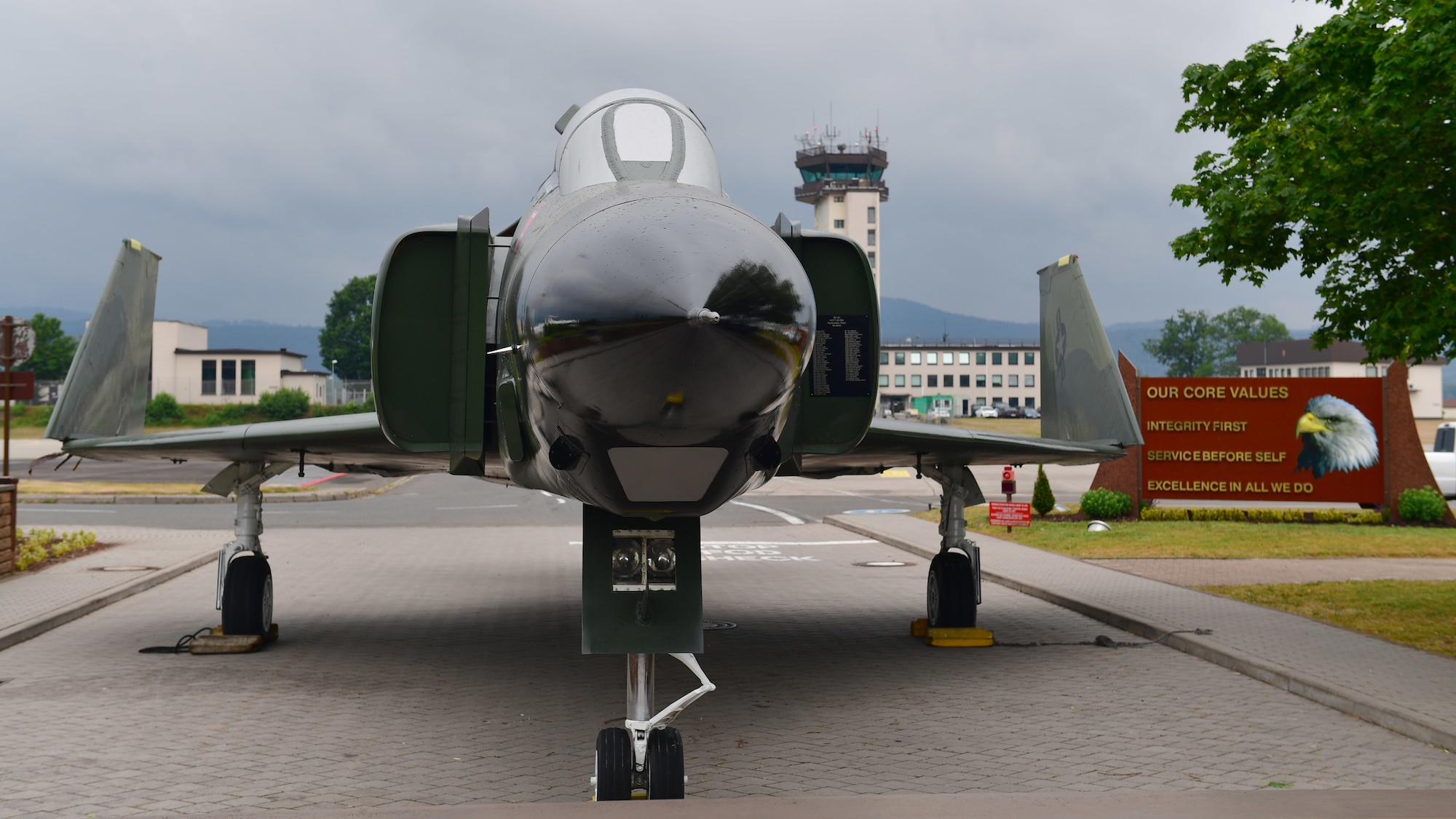 A jet aircraft sits next to a flight line.