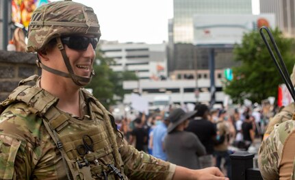 Staff Sgt. David Knicely talks to protesters across the fence line near the entrance to Atlanta's Centennial Olympic Park June 6, 2020, explaining the National Guard’s mission to ensure the right of peaceful free speech.
