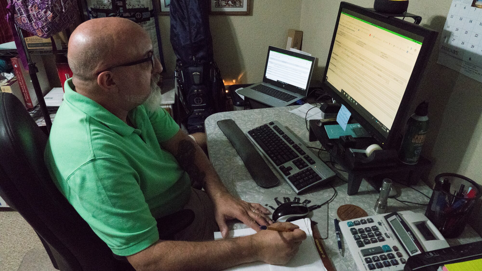 Barry Argento, the 403rd Wing comptroller and budget officer, takes notes while working from home March 27, 2020 in Ocean Springs, Mississippi. Argento leads an office of 9 civilians and 8 military traditional reservists, which services approximately 1500 Airmen. (U.S. Air Force photo by Tech. Sgt. Christopher Carranza)