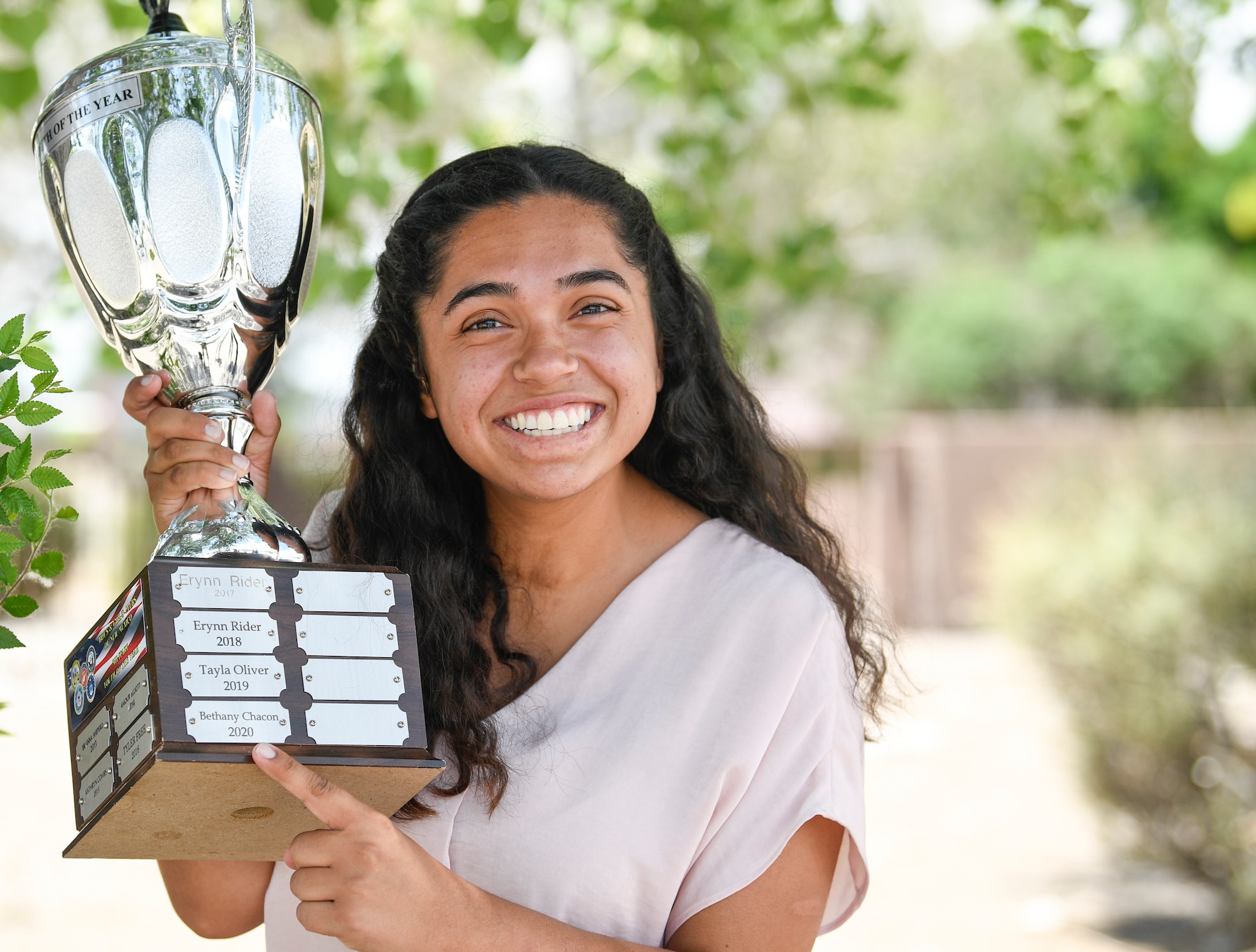 A girl holds her trophy.