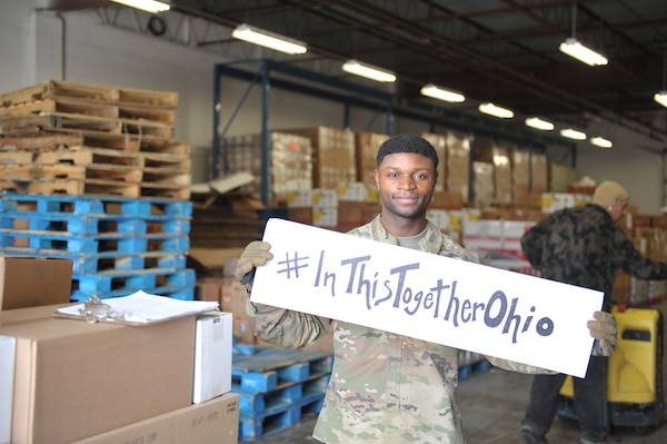 U.S. Army National Guard Soldier, Spc. Jacque Elama, assigned to the Ohio National Guard’s HHC 1-148th Infantry Regiment – 37th Infantry Brigade Combat Team,, shares a message of togetherness while serving at the Toledo Northwestern Ohio Food Bank, March 26, 2020. Nearly 400 Ohio National Guard members were activated to provide humanitarian missions in support of COVID-19 relief efforts, continuing The Ohio National Guard’s long history of supporting humanitarian efforts throughout Ohio and the nation.
