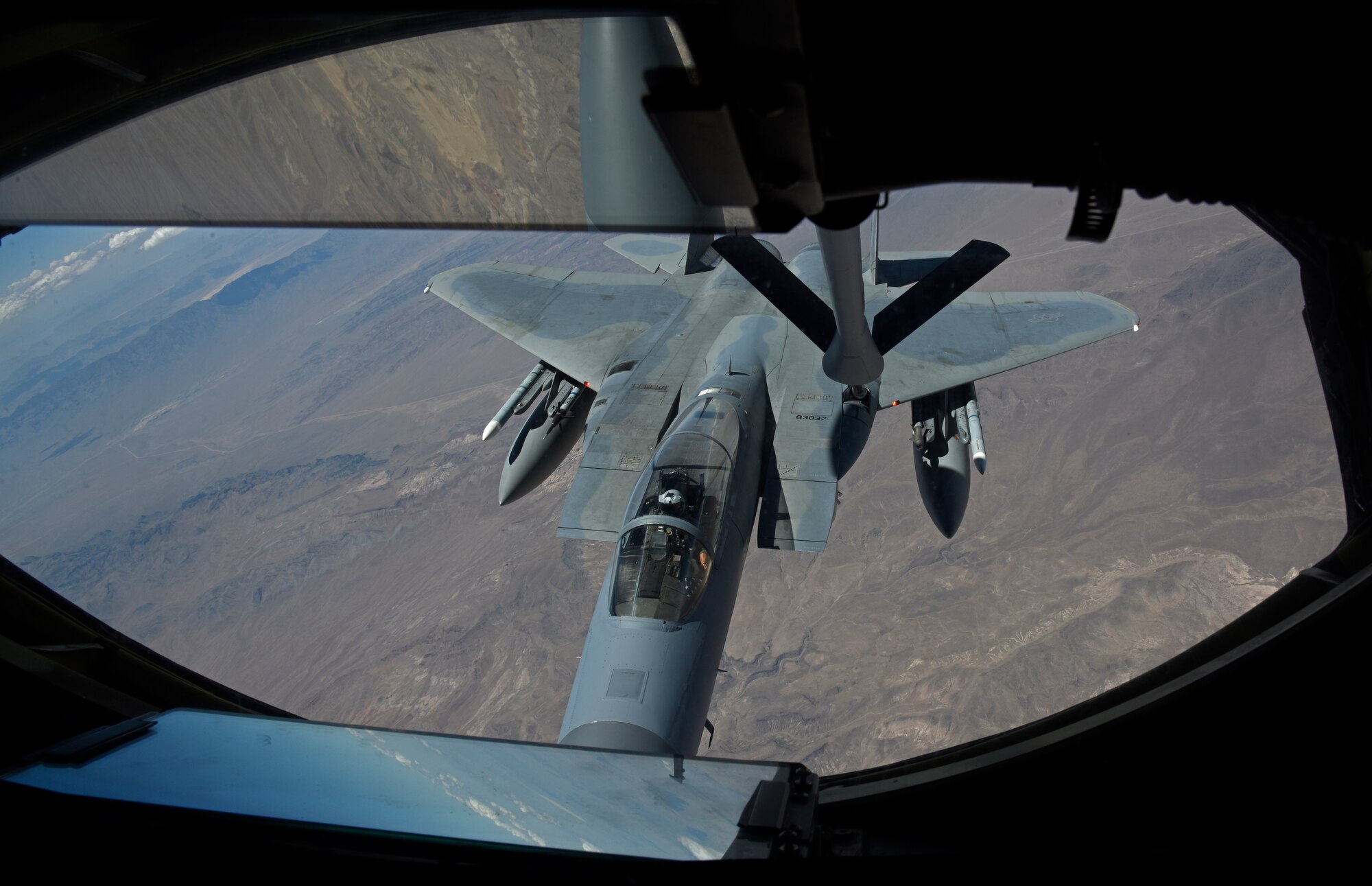 An U.S. Air Force F-15 Eagle receives fuel from a KC-135 Stratotanker belonging to Fairchild Air Force Base during the Weapons School Integration at Nellis Air Force Base, Nevada, June 4, 2020. Fairchild partnered with the 509th Weapons Squadron for their Weapons School Integration capstone exercise to host over 150 aircraft and perform peer-to-peer combat training. (U.S. Air Force photo by Senior Airman Jesenia Landaverde)
