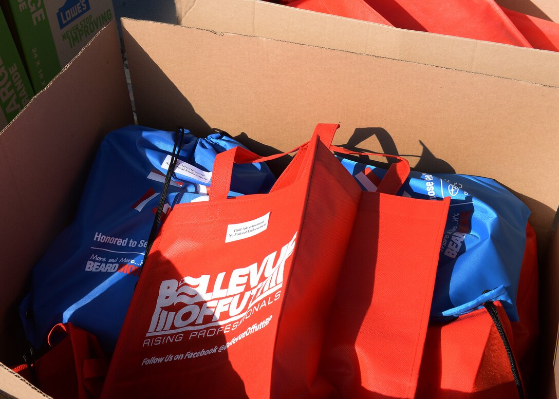 Cardboard box filled with bags that will be used for snack giveaway.