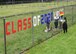 Members of the Hanscom Resilience Cell spell out a congratulatory message in a chain link fence for the graduating class of 2020 on Hanscom Air Force Base, Mass., June 5. The members also prepared ‘congrats baskets’ filled with candy and notes of encouragement for Hanscom-connected seniors from Bedford and Shawsheen High Schools, Hanscom Middle School and other local institutions. (U.S. Air Force photo by Linda LaBonte Britt)