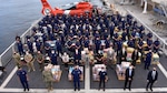 he Coast Guard Cutter James crew and interagency partners stand amongst 30,000 pounds of interdicted narcotics.