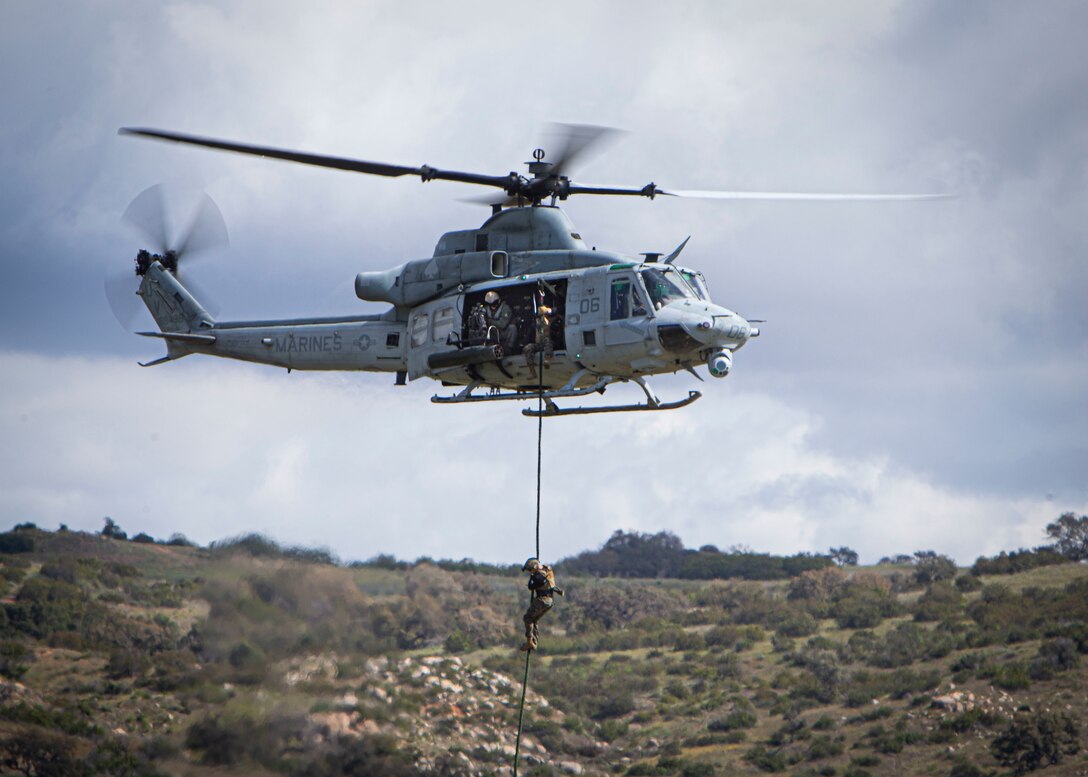 U.S. Marines fast rope out of a UH-1Y Venom helicopter during an aerial gunnery demonstration at Marine Corps Base Camp Pendleton, Calif., March 7.
