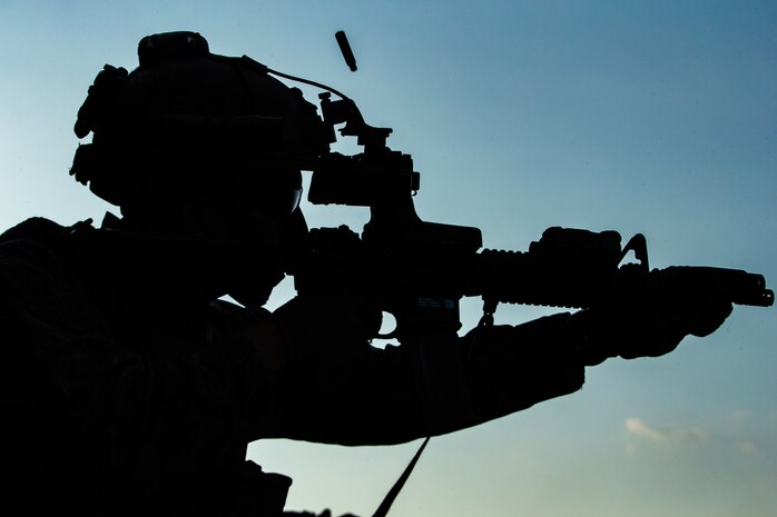 A U.S. Marine fires his M4A1 service rifle during a deck shoot aboard amphibious assault ship USS America, March 26.