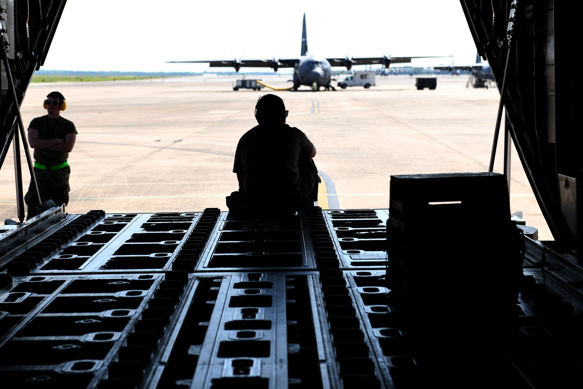 Maintainers wait to send-off a C-130J Super Hercules for a Joint Forcible Entry exercise at Little Rock Air Force Base, Arkansas, June 6, 2020. Each C-130J within the JFE exercise simulated dropping approximately 70 paratroopers while in the formation. (U.S. Air Force photo by Senior Airman Kristine M. Gruwell)