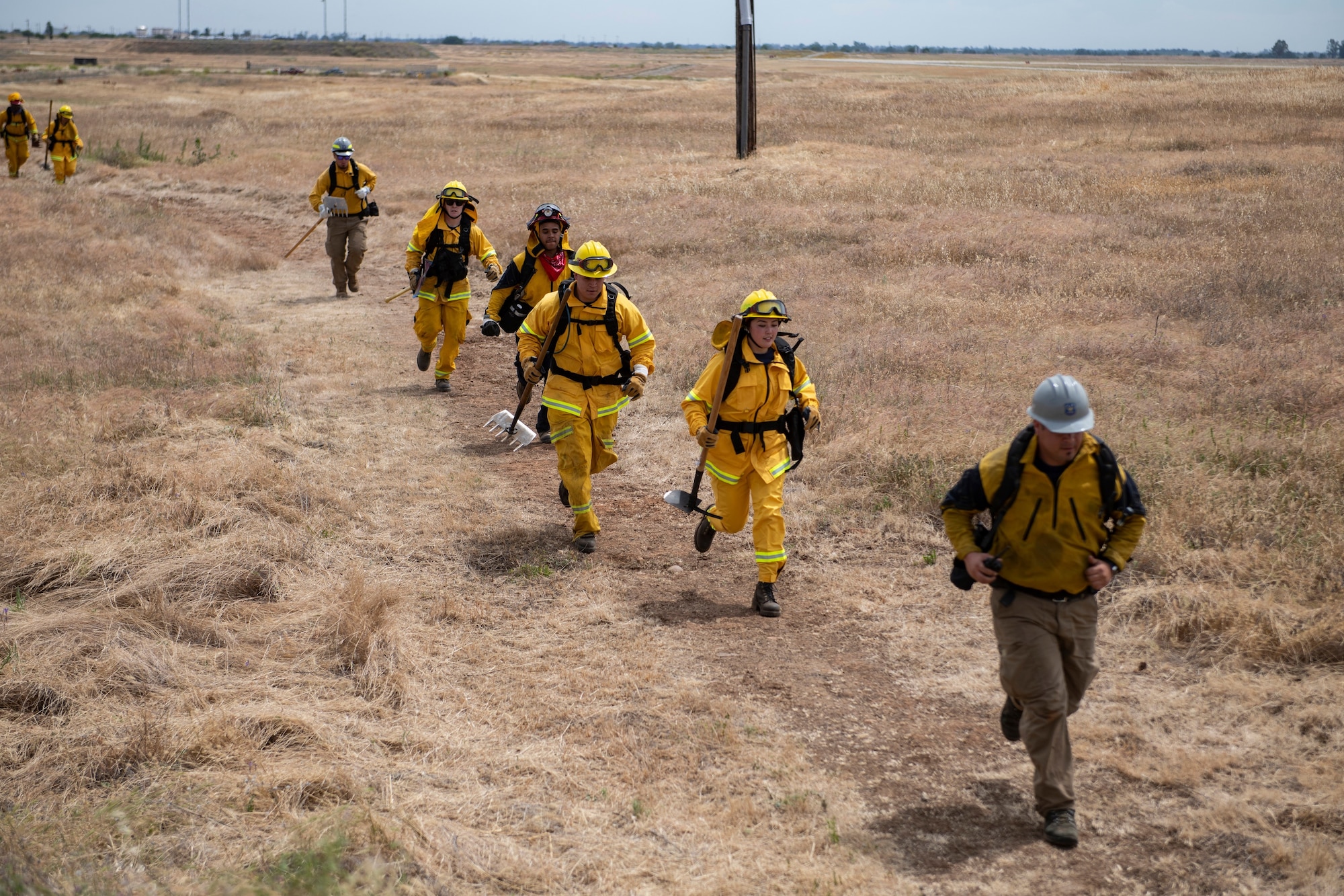 9th Civil Engineer Squadron firefighters run in response to a call of a wildfire on Beale Air Force Base.