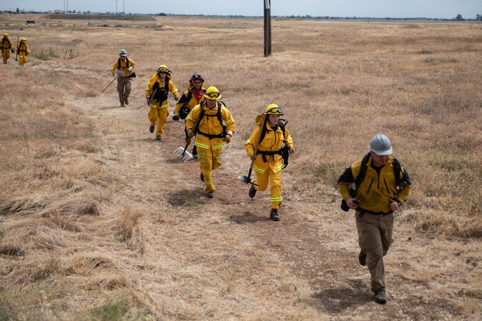 9th Civil Engineer Squadron firefighters run in response to a call of a wildfire on Beale Air Force Base.