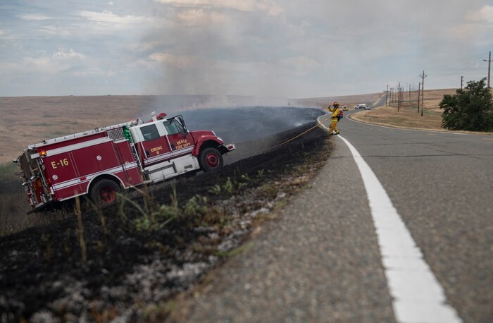A 9th Civil Engineer Squadron firefighter directs the driver up a slope on Beale Air Force Base.