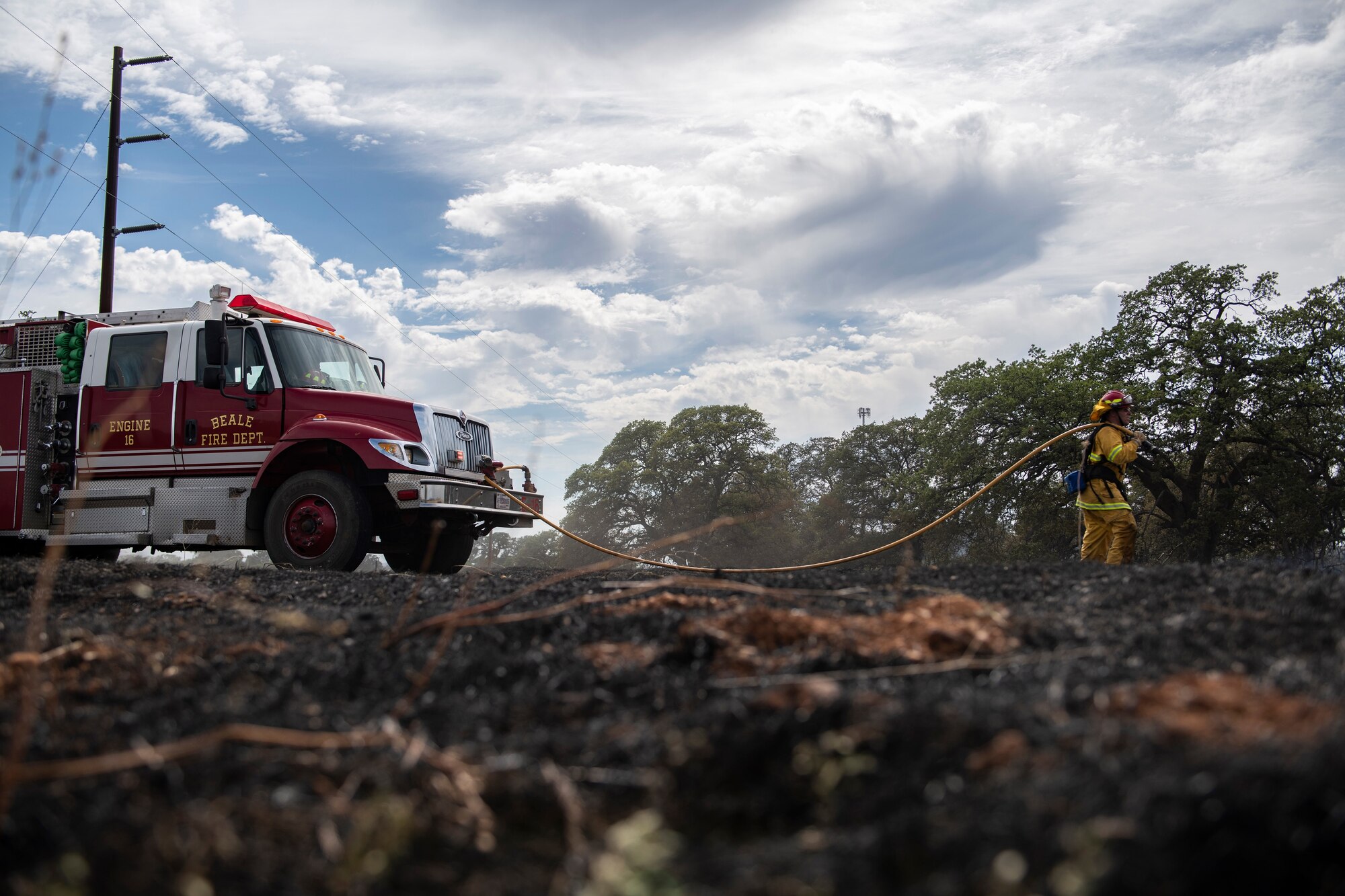 9th Civil Engineer Squadron firefighters extinguish hot spots of a wildfire on Beale Air Force Base.