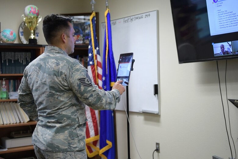 U.S. Air Force Tech. Sgt. Fransisco Jimenez, 17th Force Support Squadron Airman Leadership School instructor, uses Zoom for Government to talk with class 20-E in the Consolidated Learning Center, Goodfellow Air Force Base, Texas, June 4, 2020. The students of 20-E were the first class to be taught via Zoom at Goodfellow, to maintain safety guidelines put in place due to COVID-19. (U.S. Air Force photo by Senior Airman Zachary Chapman)