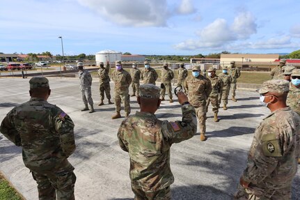 Sgt. First Class Philip Biacan, center, briefs Guam National Guard Soldiers and Airmen at the GUNG Barrigada Readiness Center before they leave to various educational traffic control points throughout the island April 14. The GUNG is supporting the government of Guam during the battle against COVID-19.