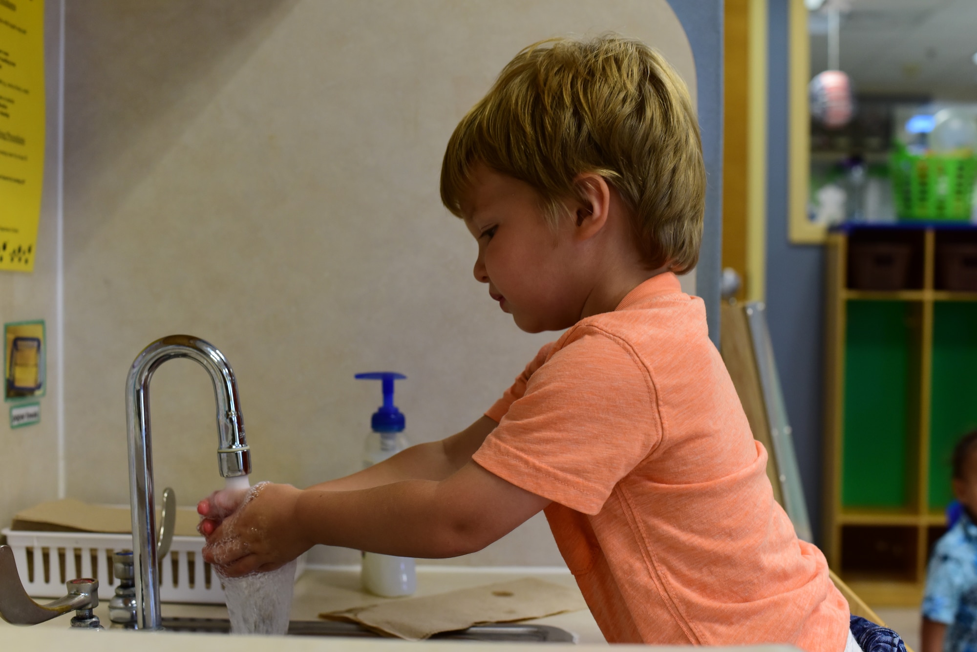 A child from the Child Development Center at Laughlin Air Force Base, Texas, washes his hands between activities, June 5, 2020. Even before the outbreak of COVID-19, the caretakers led the children in washing of hands before meals, between activities and such. (U.S. Air Force Photo by Senior Airman Anne McCready)