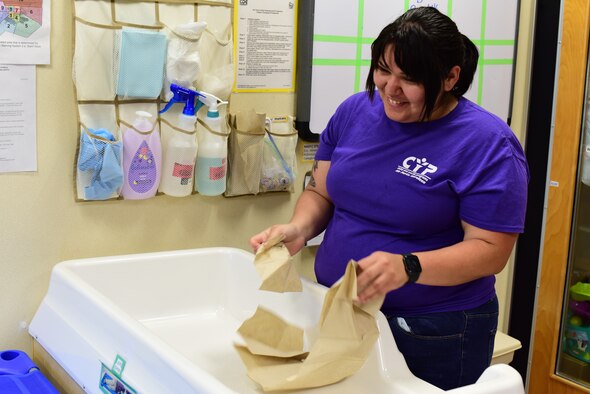 Francis Gonzalez 47th Force Support Squadron Child Development Center program assistant sanitizes a changing table at the CDC at Laughlin Air Force Base, Texas, on June 5, 2020. They sanitized their toys and frequently-touched surfaces after each day, between nap times and anytime an object needs a particularly good scrub. (U.S. Air Force Photo by Senior Airman Anne McCready)