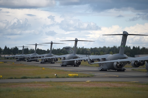 A formation of C-17 Globemaster IIIs from the 62nd Airlift Wing, 446th Airlift Wing, and Joint Base Elmendorf-Richardson, Alaska, prepare to take off from Joint Base Lewis-McChord, Wash., June 6, 2020. These aircraft made up a small portion of the 87 total that participated in a weapons instructor course joint force training exercise over the Nevada Test and Training Range. (U.S. Air Force photo by Airman 1st Class Mikayla Heineck)