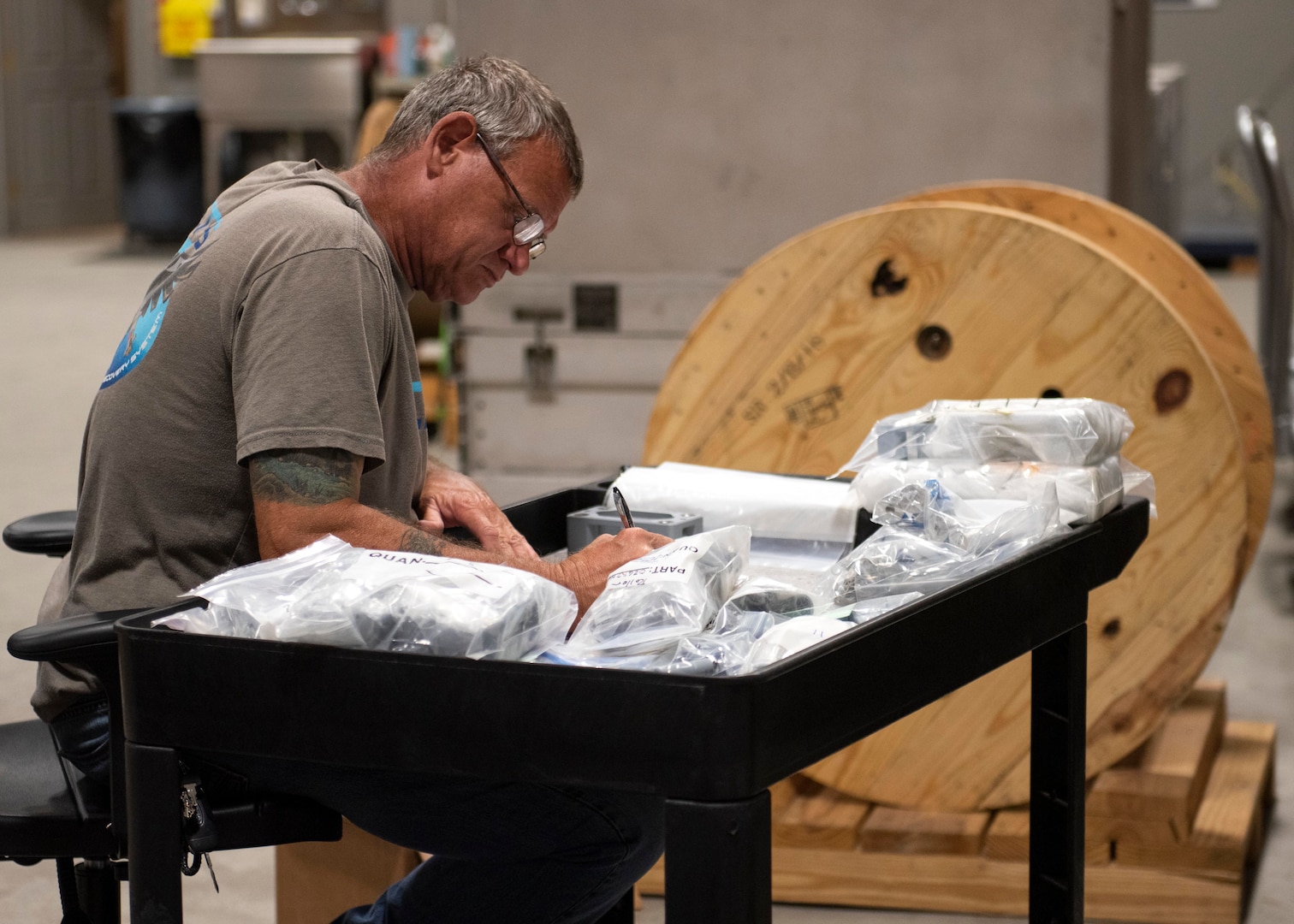 Joe Reinzo, Sr. Carriage, Stream, Tow, and Recovery System (CSTRS) technician, tags parts for installation with the next CSTRS overhaul at the CSTRS Depot May 5.