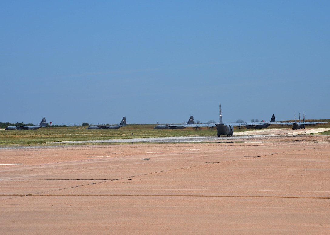 A line of C-130J Super Hercules taxi along the flightline at Dyess Air Force Base, Texas in preparation for an U.S. Air Force Weapons School Joint Forcible Entry exercise June 6, 2020. Approximately eight of Dyess’ aircraft took part in the exercise at Nellis AFB, Nev. (U.S. Air Force photo by Senior Airman Mercedes Porter)