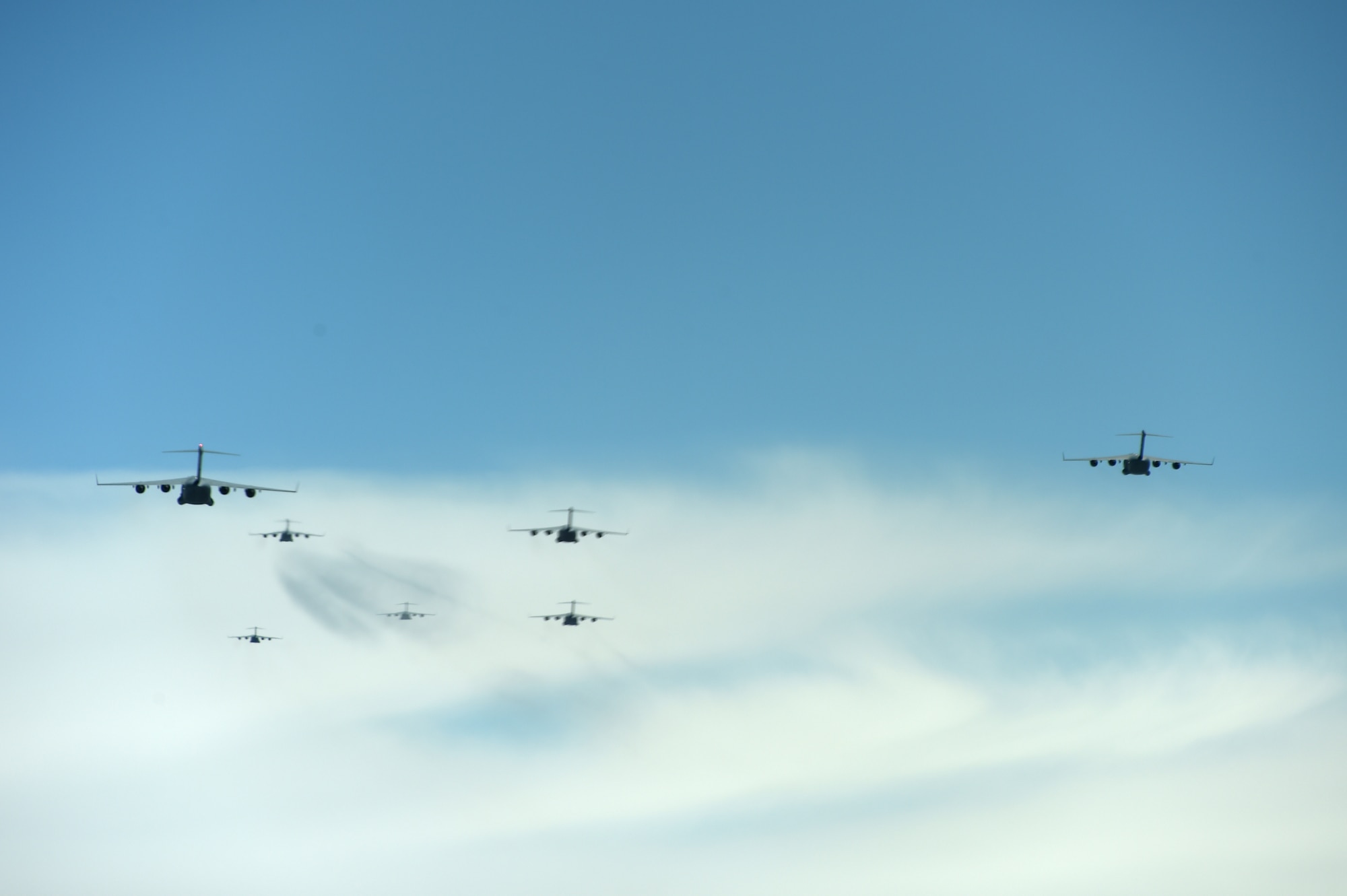 A formation of C-17 Globemaster III aircrafts from the 62nd Airlift Wing, 446th Airlift Wing, and Joint Base Elmendorf-Richardson, fly in a joint force exercise over the Nevada test and training range, June 6, 2020. The C-17’s made up a section of the 87 total aircraft that participated in this exercise which was the capstone event for a weapons instructor course class. (U.S. Air Force photo by Airman 1st Class Mikayla Heineck)