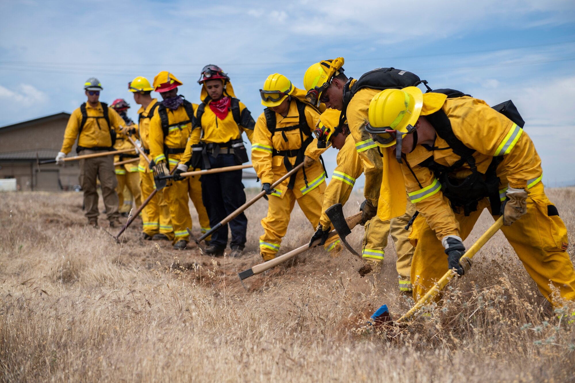 9th Civil Engineer Squadron firefighters practice cutting line.