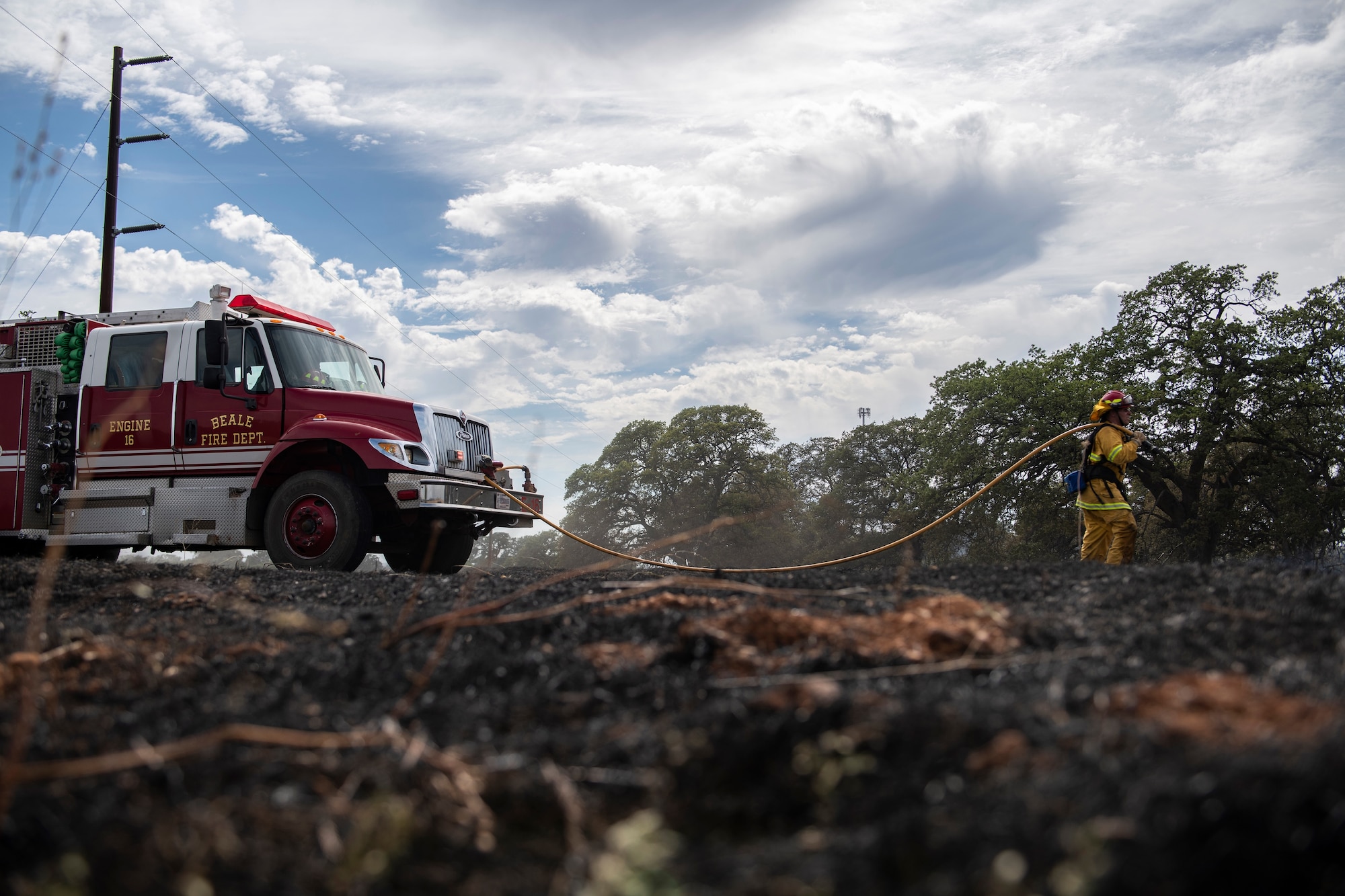 9th Civil Engineer Squadron firefighters extinguish hot spots of a wildfire on Beale Air Force Base.