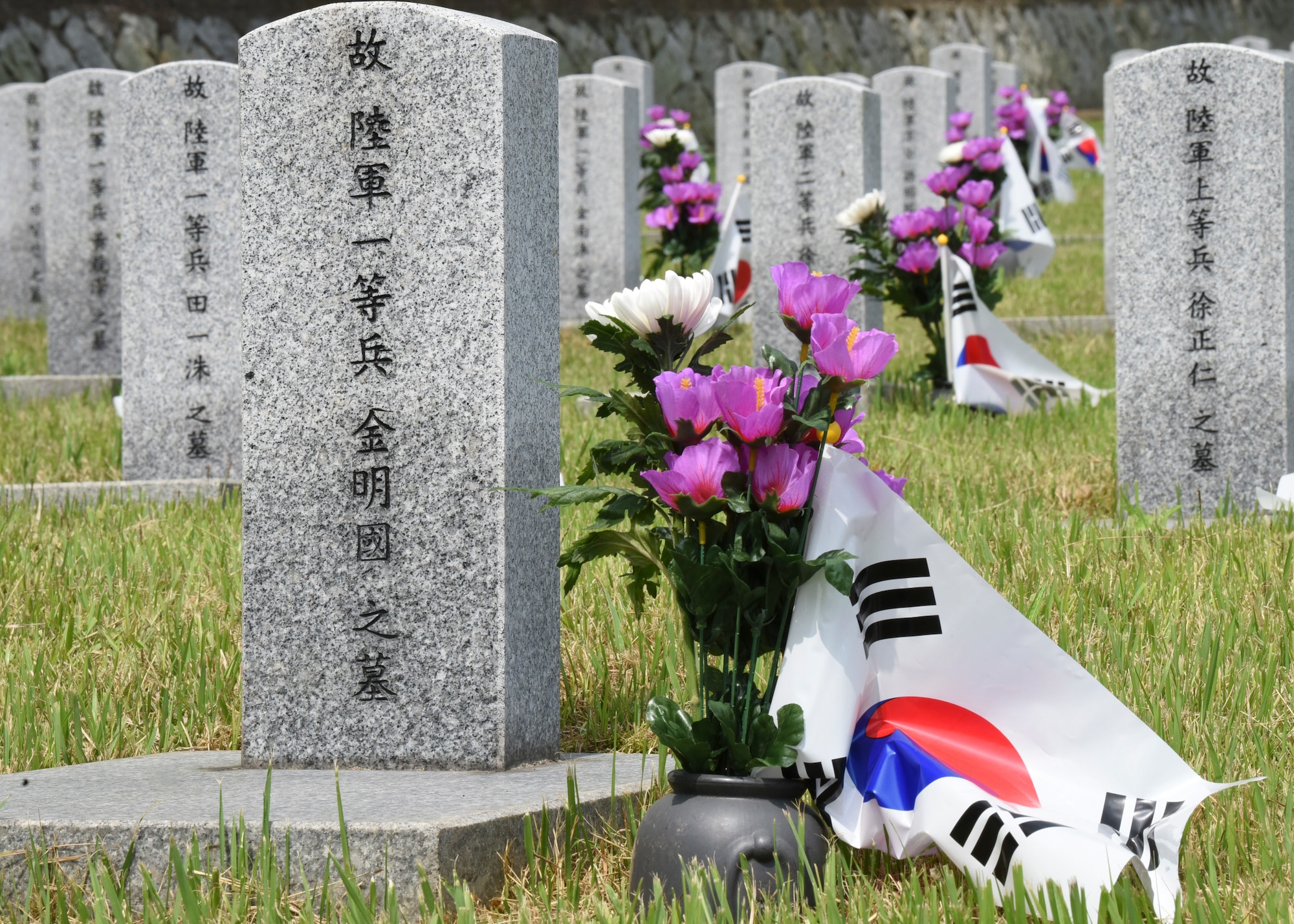 The Korean Memorial Day ceremony in Gunsan City, Republic of Korea, commemorates the lives of Korean citizens who died while serving in the military and those who lost their lives during the independence movement, June 6. Each headstone in the cemetery was honored with flowers and national flag during the Korean Memorial Day holiday. (U.S. Air Force photo by Staff Sgt. Anthony Hetlage)