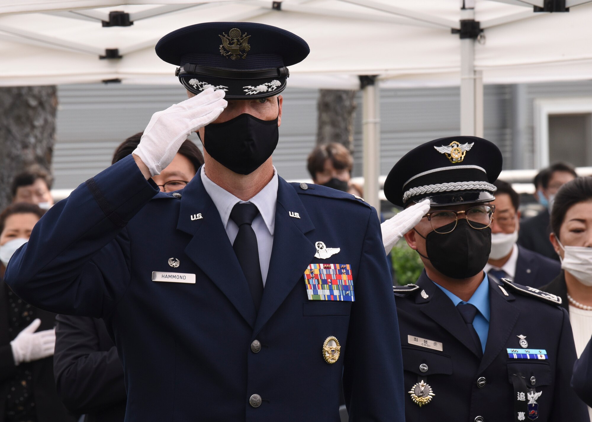 U.S. Air Force Col. Chris Hammond, 8th Fighter Wing commander, salutes in respect to the fallen during the Korean Memorial Day ceremony in Gunsan City, Republic of Korea, June 6, 2020. The Korean citizens who died while serving in the military and those who lost their lives during the independence movement were honored with white carnations during the ceremony while flags and flowers were displayed at each headstone. (U.S. Air Force photo by Staff Sgt. Anthony Hetlage)